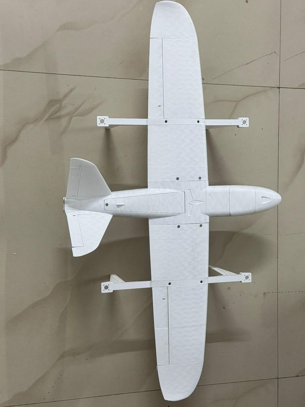 A white 3D-printed custom aircraft airframe