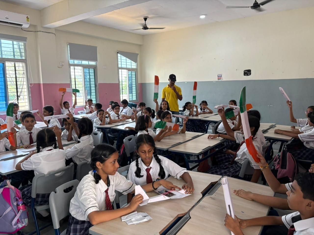 A classroom of students flying the gliders they built